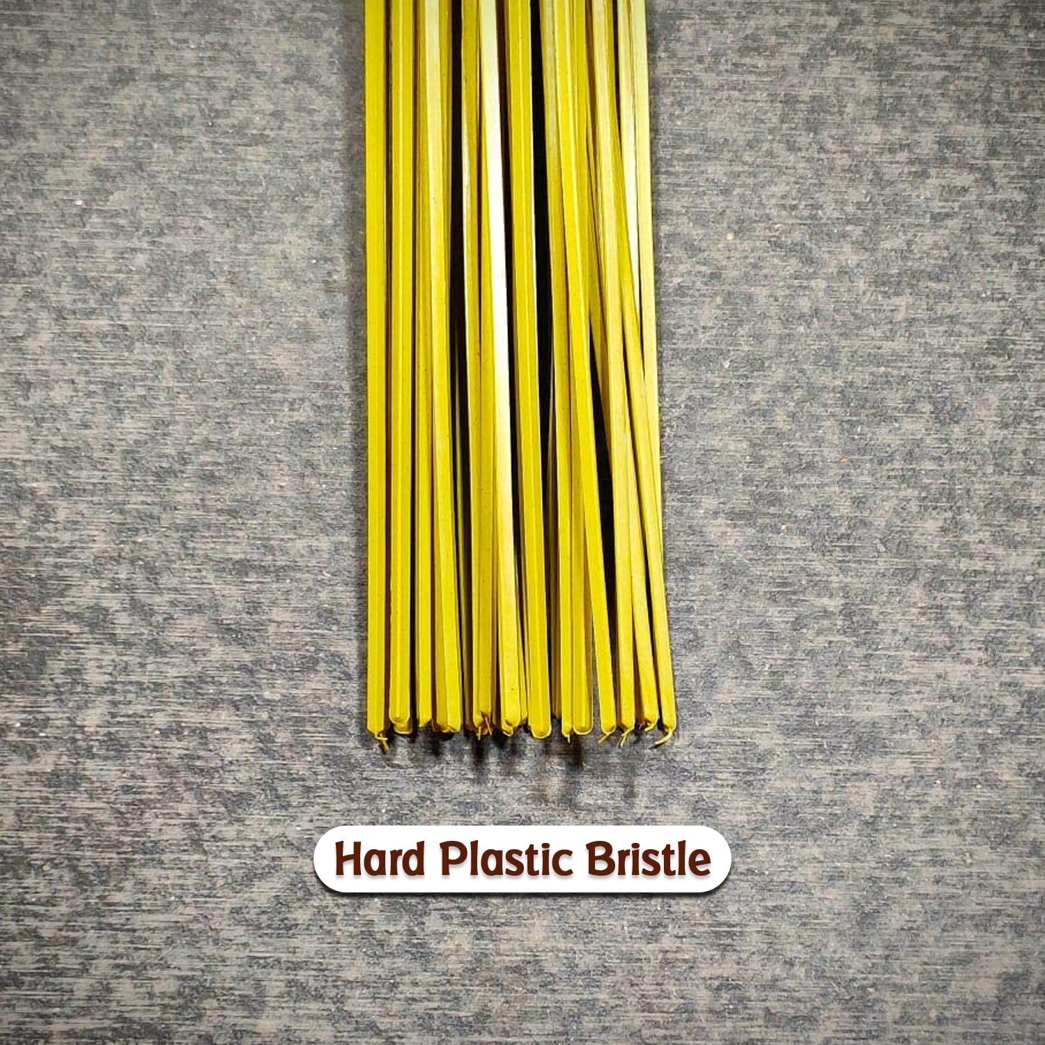 Hard bristle broom with plastic handle, close-up of bristles Hard bristle broom with plastic handle, close-up of bristles